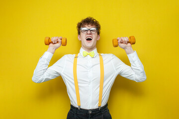 nerd student in shirt with bow tie and suspenders goes in for sports, young guy in festive outfit...