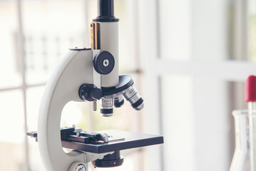 Science microscope equipment in biology chemical laboratory. Scientific experiment Microscope on Lab table microbiology equipment. Chemistry objects on lab background. Chemistry scientific concept