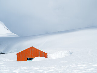 Orange red hut in deep snow