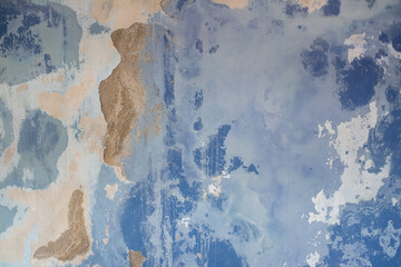 Peeling blue paint on wall