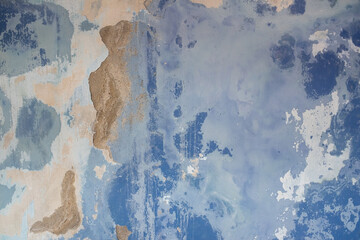 Peeling blue paint on wall
