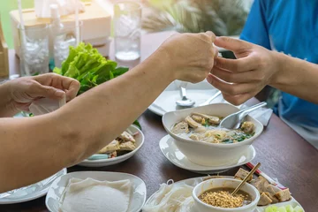 Foto op Canvas Enjoy eat with Vietnamese Meatball Wraps (Nam-Neung), Pork Sausage wraps with fresh vegetables in rice paper, generous platter eat with sweet sauce. Vietnamese Pork Sausage and salad. Selective focus. © JinnaritT