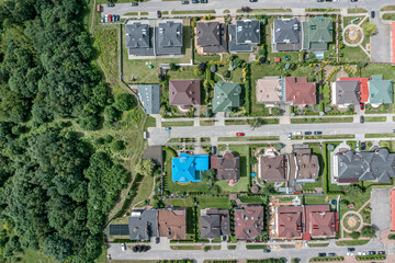 aerial drone photo of a residential area with houses and gardens from height