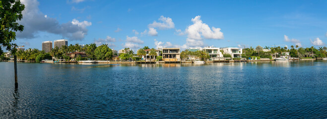 Fototapeta na wymiar Miami Beach, Florida- intracoastal waterway residential area at Biscayne Bay panorama. There are waterfront two-storey houses with private docks near the modern buildings on the left.