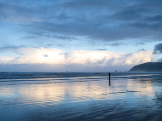Man taking photo's silhouette reflected on beach