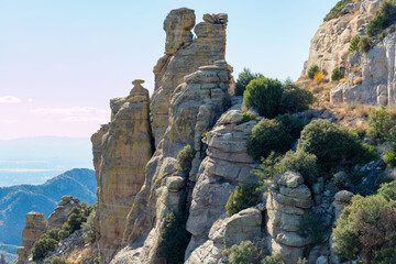 Hanging rock formations with the stones of arizona desert in late afternoon shade and sun with...