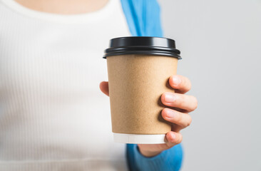 Hands holding mockup a coffee paper cup isolated on white background.