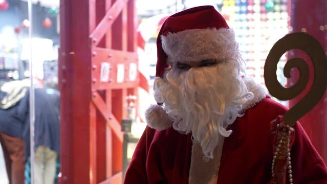 Santa Claus at a shopping street waving