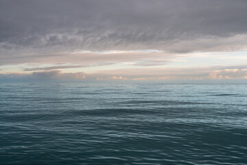 View of the Black Sea on the coast of Sochi against the sunset sky, Sochi, Krasnodar Krai, Russia