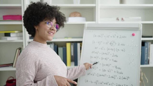 Young african american woman teacher teaching maths lesson at university classroom