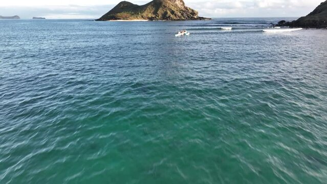 Aerial Pan Up Of Mokulua Islands In Lanikai Hawaii With Paddlers In Hawaii Canoes And Beach Views