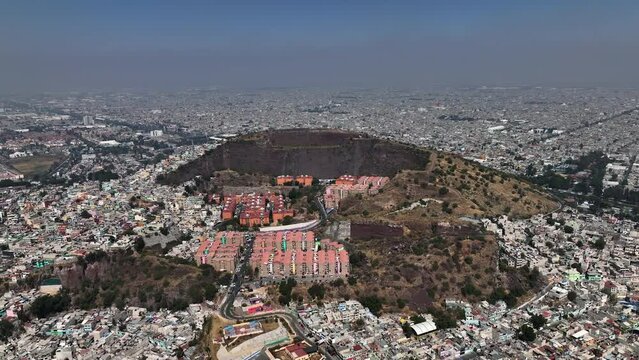 Aerial view approaching a apartment buildings inside the Volcán Cerro crater, in Iztapalapa, Mexico city