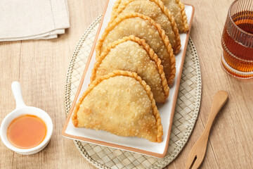 Jalangkote, Indonesian traditional snack filled with egg, carrot, potato, rice noodles. Served with chili sauce
