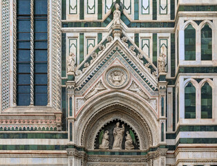 Fototapeta na wymiar Ornate marble facade of the famous Duomo Cathedral in Florence, Italy