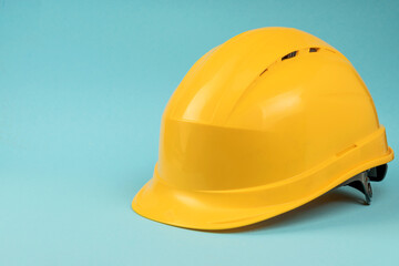 Construction helmet yellow on a blue background. Construction concept