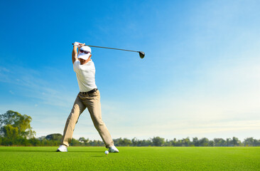 Asian man golfer driver swing before hitting golf ball down the fairway. - obrazy, fototapety, plakaty
