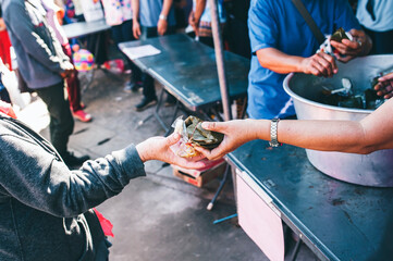 Hands of hungry people asking for free food from volunteers : humanitarian aid concept