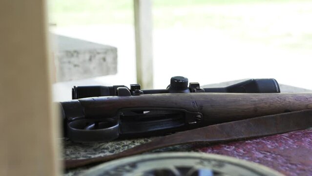 Closeup Of A Wooden Rifle On The Table At The Firing Range. handheld shot