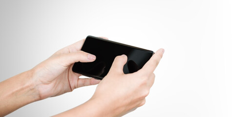 Cropped shot view of hands holding smart phone with blank copy space screen.