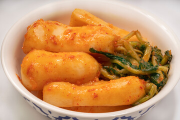 Bachelor kimchi on white background or Radish kimchi with Ponytail radish Korean traditional fermented vegetable a side dish at meals.