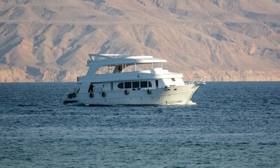 The yacht floats on the water in the sea.