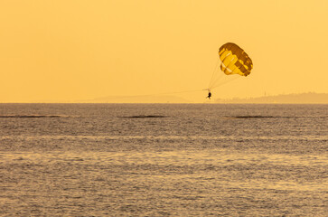 Parachute flies over the water of the sea