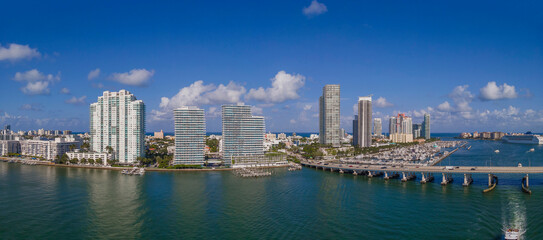 Fototapeta na wymiar Panoramic view of the Miami Beach Florida skyline and the Intracoastal Waterway. The modern buildings has a magnificent view of the manmade inland water channel and blue sky.