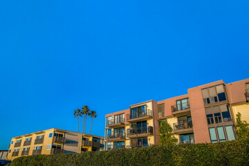 Multi-storey houses against clear blue sky background at Del Mar California. Facade of homes with balconies by the beach on a seaside neighborhood on a sunny day.