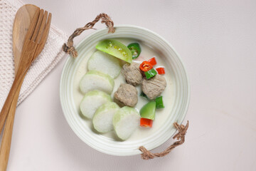 Cok Ganem or Gecok Ganem or Kecok Ganem is an Indonesian Traditional Royal Dish from Yogyakarta, made from Meatball in Coconut Milk Syrup, Dominated by Sour and Spicy Flavors, Served with Rice Cake.