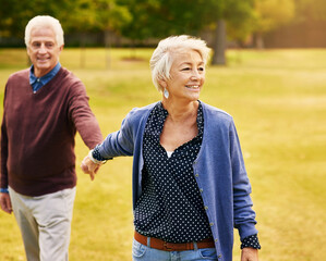 Romance, retirement and old couple holding hands in field, walking in nature and happy smile on grass. Peace, senior man and woman on romantic walk in park, health and love on holiday in countryside.