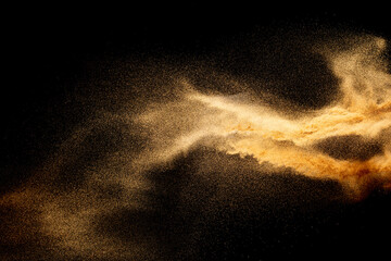 Sand explosion isolated on black background. Freeze motion of sandy dust splash.Sand texture concept. - obrazy, fototapety, plakaty