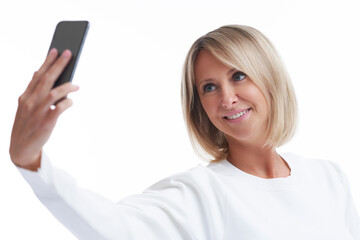 Picture of blonde woman over back isolated background with mobile phone