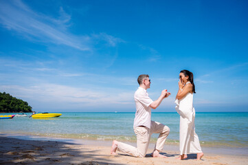 Man and Women in beautiful white dresses On beach.Day of Love and Marriage concept