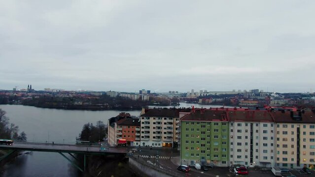 Soft tilt down from sky on to capital Stockholm in Sweden on grey day