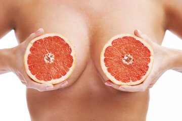 Picture of middle part woman body or breast with grapefruit