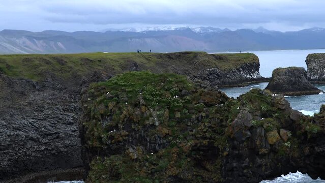 Rock reaching out of Water at Arnarstapi on Peninsula Sn&aelig;fellsnes in Iceland, 4K