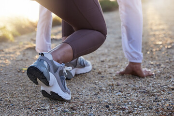 Fitness, shoes or runner ready to start running workout, sports exercise or cardio training outdoors. Wellness, legs or healthy girl with commitment, resilience or motivation for exercising in race