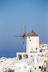Fototapeta na wymiar Domes, steeples, bells and white buildings of Santorini, Greece 