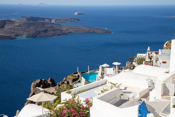 Obraz premium Domes, steeples, bells and white buildings of Santorini, Greece 