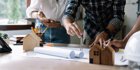 engineer and architect people meeting working and hand drawing on blueprint and briefing with his colleague. Engineering tools and construction concept