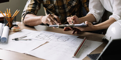 Architecture engineering teamwork meeting at workplace to plan drawing a new blueprint busy working...