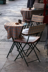 Chairs and tables in an outdoor cafe.