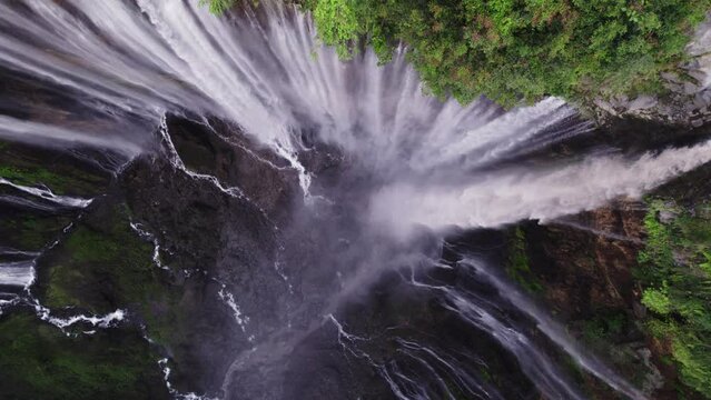 Multiple waterfalls flowing into steep canyon in East Java, Tumpak Sewu, top down
