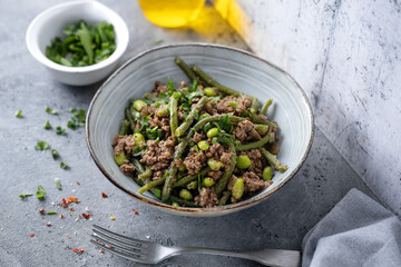 Green beans with minced meat in bowl