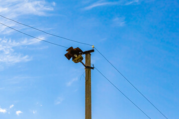 Power electric pole with line wire on colored background close up