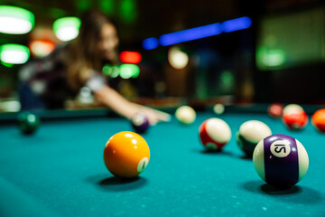 Preparing to break spheres into the pool pocket. People billiard, snooker entertainment concept.