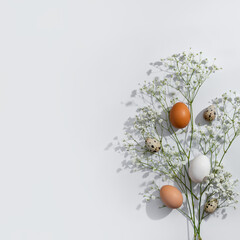 Elegant minimalist Easter greeting card design, natural color eggs and flowers on neutral light...
