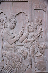 Relief depicting Hindu god Krishna with his stepmother Yashodha. India.