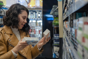 a woman chooses toothpaste in a store