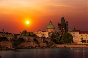 Fototapeta premium Prague with Old Town Bridge Tower and Charles bridge over Vltava river at sunset, Czechia